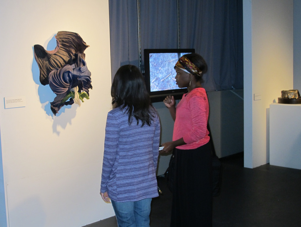 Gallery visitors check out artist Zina Castanuela's handmade paper sculpture